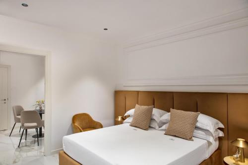 a bedroom with a bed and a table and chairs at Dama Pompei - Luxury Apartment in Pompei