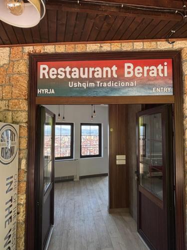 an entrance to a restaurant benefit sign in a building at Hotel Berati in Prizren