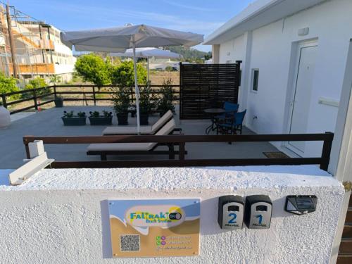 a table with two flip phones on a patio at Falirakion Beach Studios in Faliraki