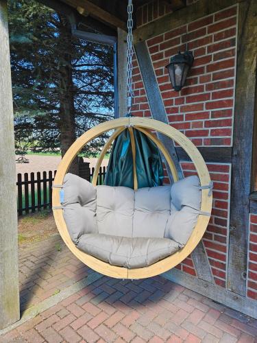 a swing hanging from a house at Landhaus Charlotte - Feldblick in Wassersuppe