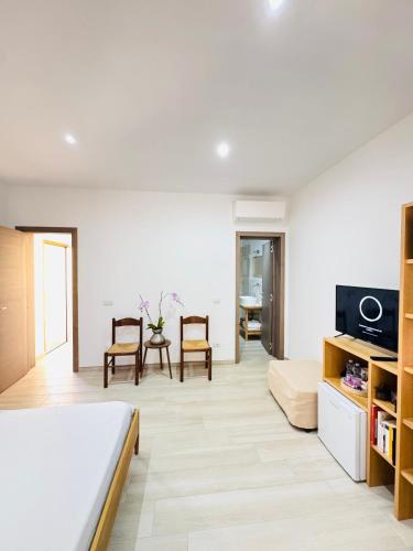 a bedroom with a bed and a living room at CASA SACURI in Rudalza