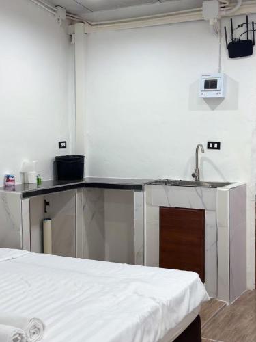 a kitchen with a sink and a counter top at Megun 10 in Ban Bang Phlat