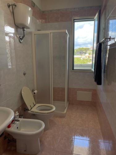 a bathroom with a toilet and a shower and a sink at House Nereide, Lovely Apartment Sea View GALLIPOLI in Gallipoli