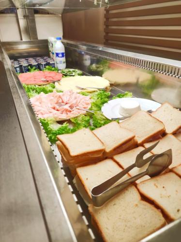 a buffet line with sandwiches and other foods at Hotel Cà Vanni in Rimini