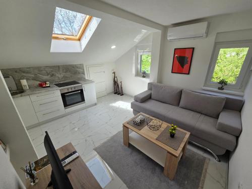 an overhead view of a living room with a couch and a table at Sarajevo Pulse Residence in Sarajevo