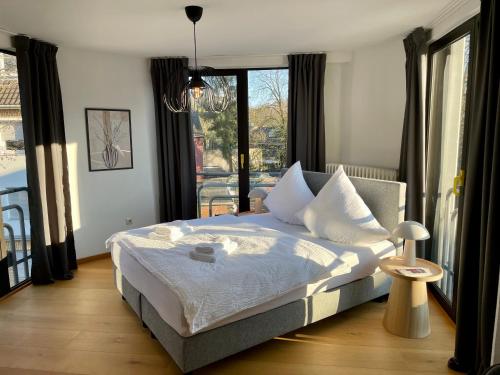 a bedroom with a bed and a large window at VIBE Altstadt Apartments - Zentral - Sonnig - Voll ausgestattet in Mönchengladbach