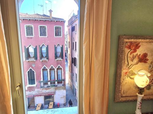a window with a view of a city at Allegretto Rialto in Venice
