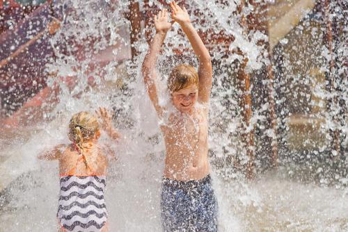 two young children playing in a water fountain at Discovery Parks - Pambula Beach in Pambula
