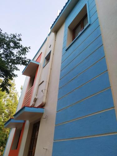 a building with blue paint on the side of it at The Last Villa in Yercaud