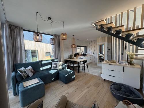 a living room with a blue couch and a kitchen at Yama Krywe in Krywe