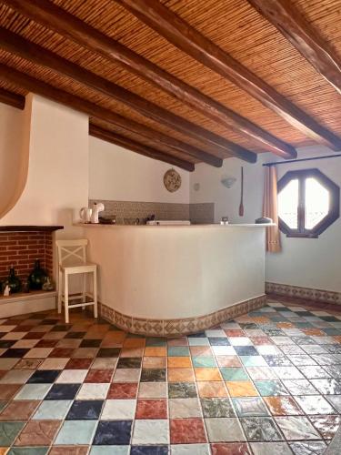a kitchen with a checkered floor in a house at Ogliastra Luxury Apartment - AJPSARDINIA in Tortolì