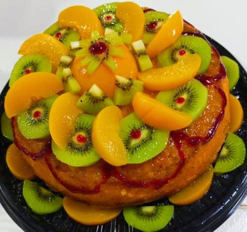 a cake with fruit on top of it on a plate at Hotel La Casa de Francois in San Agustín