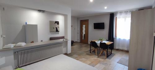 a living room with a table and a dining room at Nautica Tarello - Casa Ena BeB in Viverone
