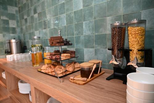 a table with pastries and other food on it at Landmark Hotel in Batumi