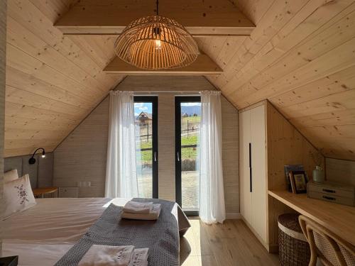 a bedroom with a bed and a large window at Yama Krywe in Krywe