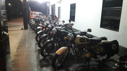 a row of motorcycles parked next to a wall at Lejo Grand Hotel in Cikembulan