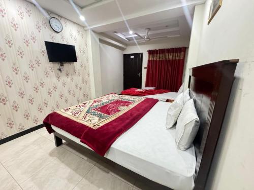 Ένα ή περισσότερα κρεβάτια σε δωμάτιο στο Libra Hotel Islamabad