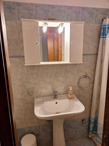 a bathroom with a sink and a mirror at Cephalonia Sami, luxury apartment. in Sami