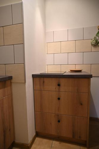 a kitchen with a wooden dresser in a room at Kocurzonka Apartamenty in Jaworzynka
