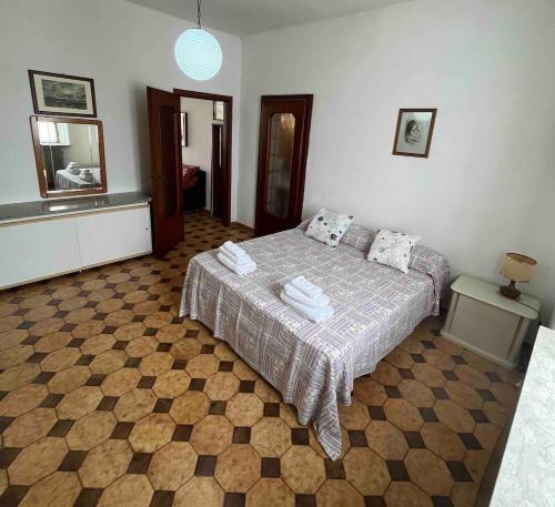 a bedroom with a bed with towels on it at Entire Apartment FabryExperience in Mozzanica