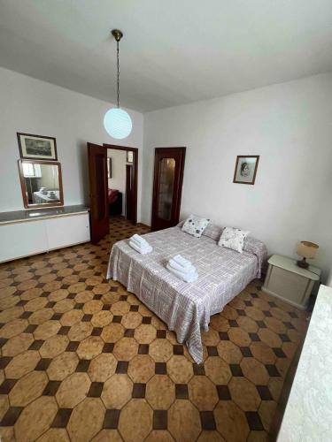 a bedroom with a bed and a checkered floor at Entire Apartment FabryExperience in Mozzanica