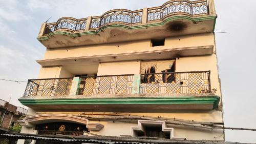 a building with a balcony on the side of it at Omprakash homestay in Padri