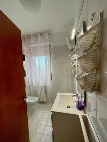 a small bathroom with a sink and a toilet at Casa vacanze a Porto Recanati in Porto Recanati