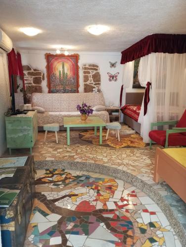 a living room with a couch and a mosaic floor at By Artist in Pićan