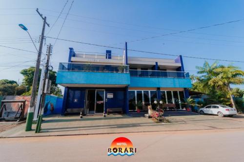 a blue building on the side of a street at Hotel Borari in Alter do Chao