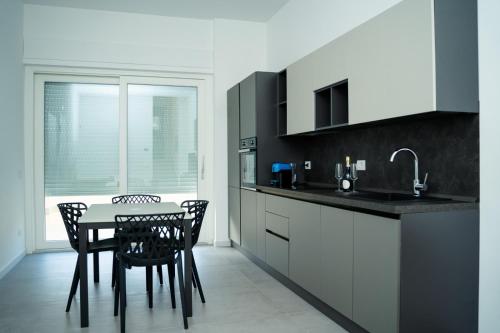 a kitchen with a table and chairs and a sink at Diamond luxury house in Monopoli