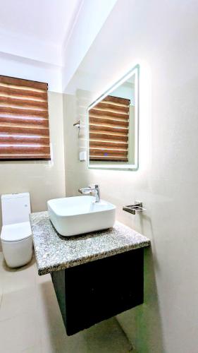 a bathroom with a sink and a toilet at Dutch Villa - Trincomalee in Trincomalee