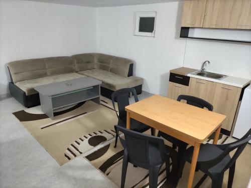 a living room with a couch and a table and chairs at SKOPJE Apartment in Skopje