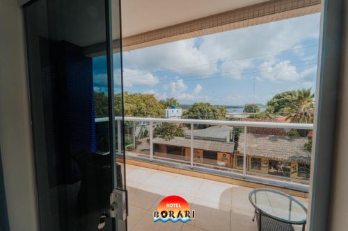 a view from the balcony of a room with a window at Hotel Borari in Alter do Chao