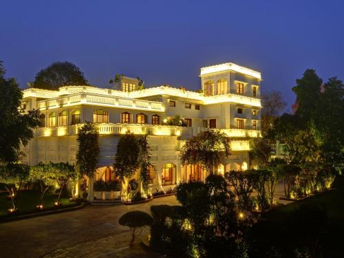 a large white building with lights on it at night at Saraca Hotel Lucknow in Lucknow