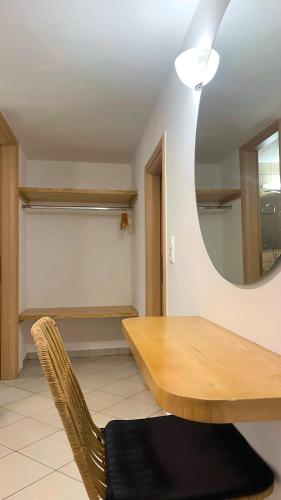 a dining room with a table and a mirror at Naxos City Haven in Naxos Chora