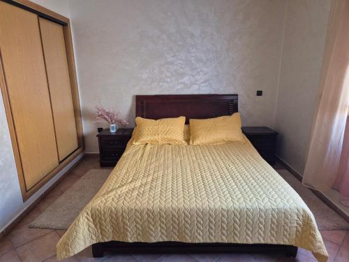 a bedroom with a bed and two night stands at Family Beach Apartment Marbella in El Jadida