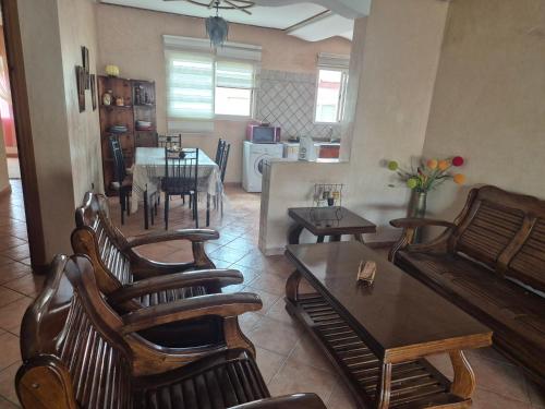 a living room with chairs and a table and a kitchen at Family Beach Apartment Marbella in El Jadida