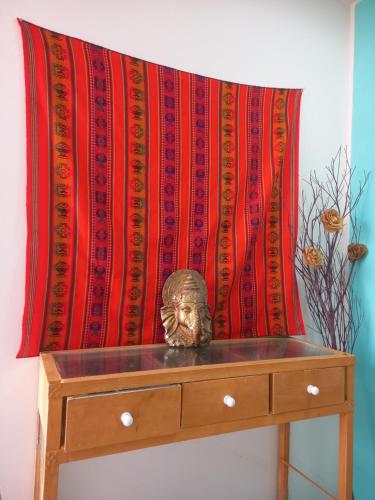 a mask sitting on a dresser in front of a blanket at VILA LEME Casa 11A in Rio de Janeiro