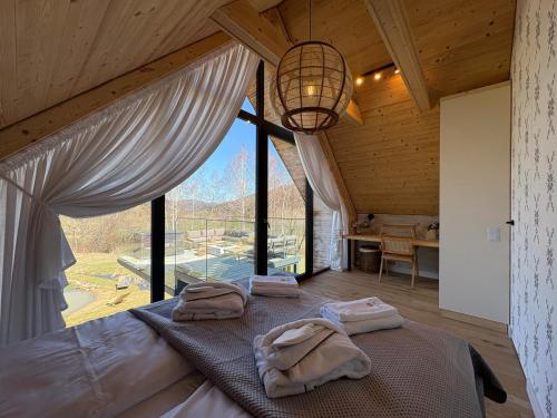 a bedroom with a bed and a large window at Yama Krywe in Krywe