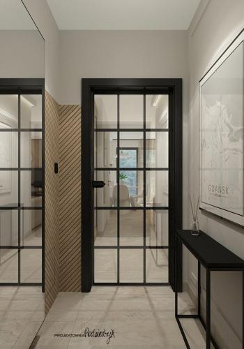a room with glass doors and a room with a table at Modern Gdańsk Wyspa Sobieszewska in Gdańsk