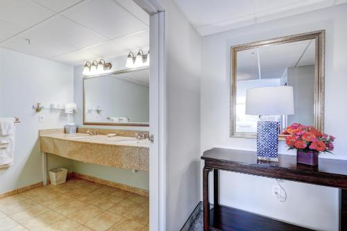 a bathroom with a sink and a mirror at Hotel Rehoboth in Rehoboth Beach