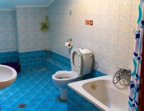 a bathroom with a toilet and a tub and a sink at Dina Apartments in Fanari