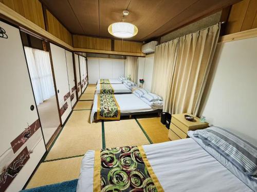 Postel nebo postele na pokoji v ubytování Shiga Biwa Lake Shanshui House