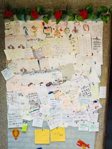 a bulletin board with many pieces of paper at Shiga Biwa Lake Shanshui House in Takashima