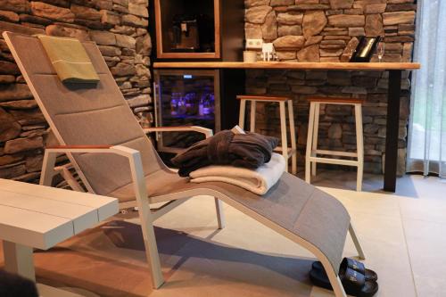 a chair sitting in a room with a counter at Loo Mare - Floating Tiny House All inclusive in Merselo