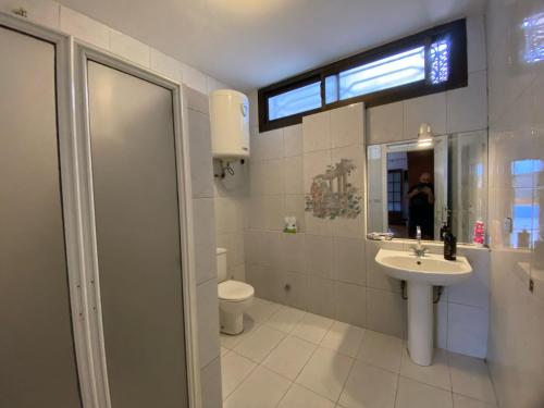 a bathroom with a sink and a toilet and a window at Villa Maadi 35 -R 3 - Poolside Master Room in Cairo