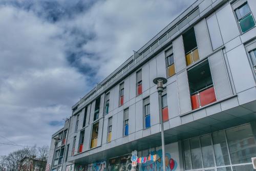 a building with colorful windows on the side of it at Bella Apartmani in Valjevo
