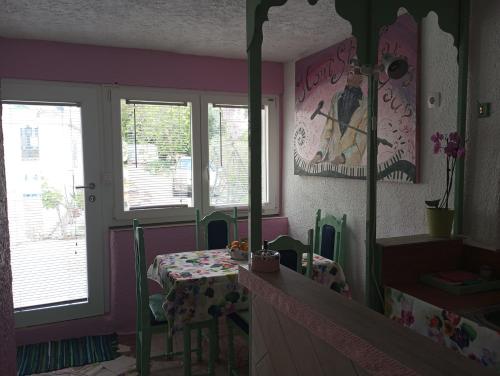 a room with a table and a mirror at By Artist in Pićan