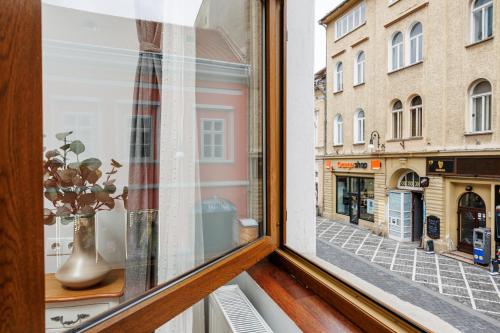 a window with a view of a city street at Wood House Republicii in Braşov