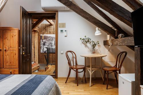 a bedroom with a bed and a table and chairs at Wood House Republicii in Braşov